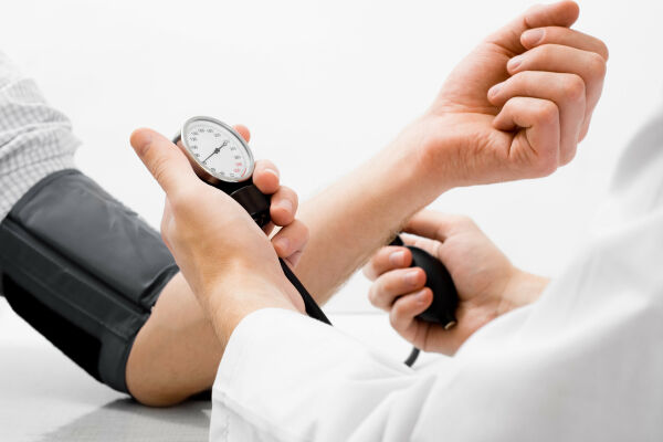 Doctor checking someones blood pressure.