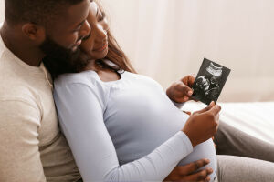 Expecting couple looking at an ultrasound image of their child.